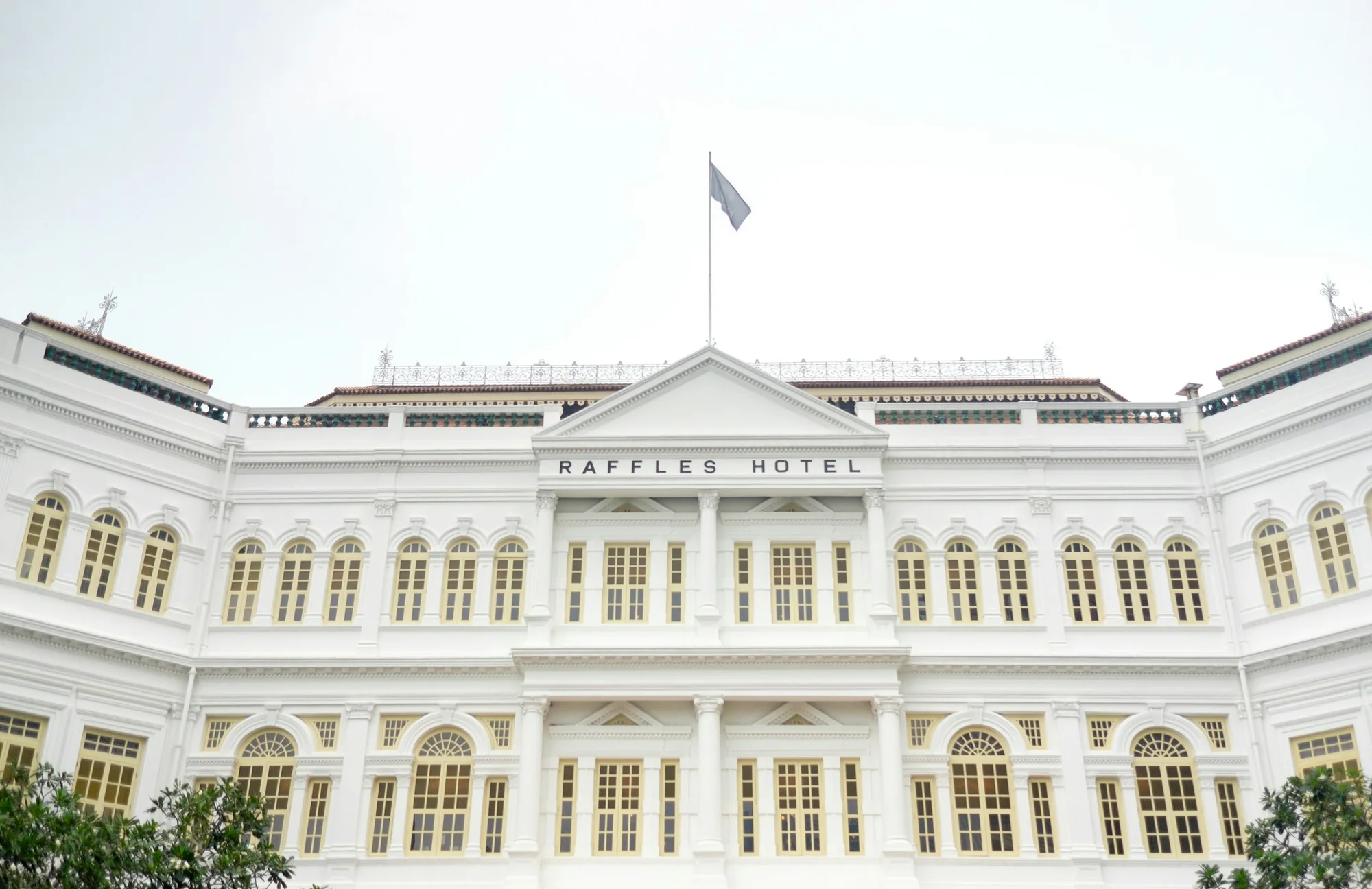 The white Raffles Hotel façade photographed before its 2019 reopening.