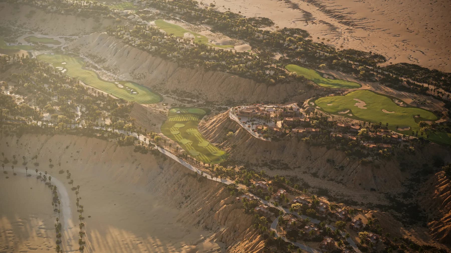 An aerial across Rayana, its golf course and the wadi beyond