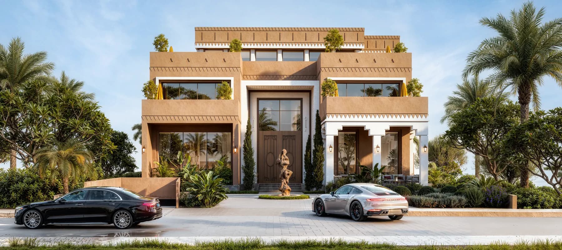 A Najdi-style mansion at dusk, its arrival court lit against the stone facade