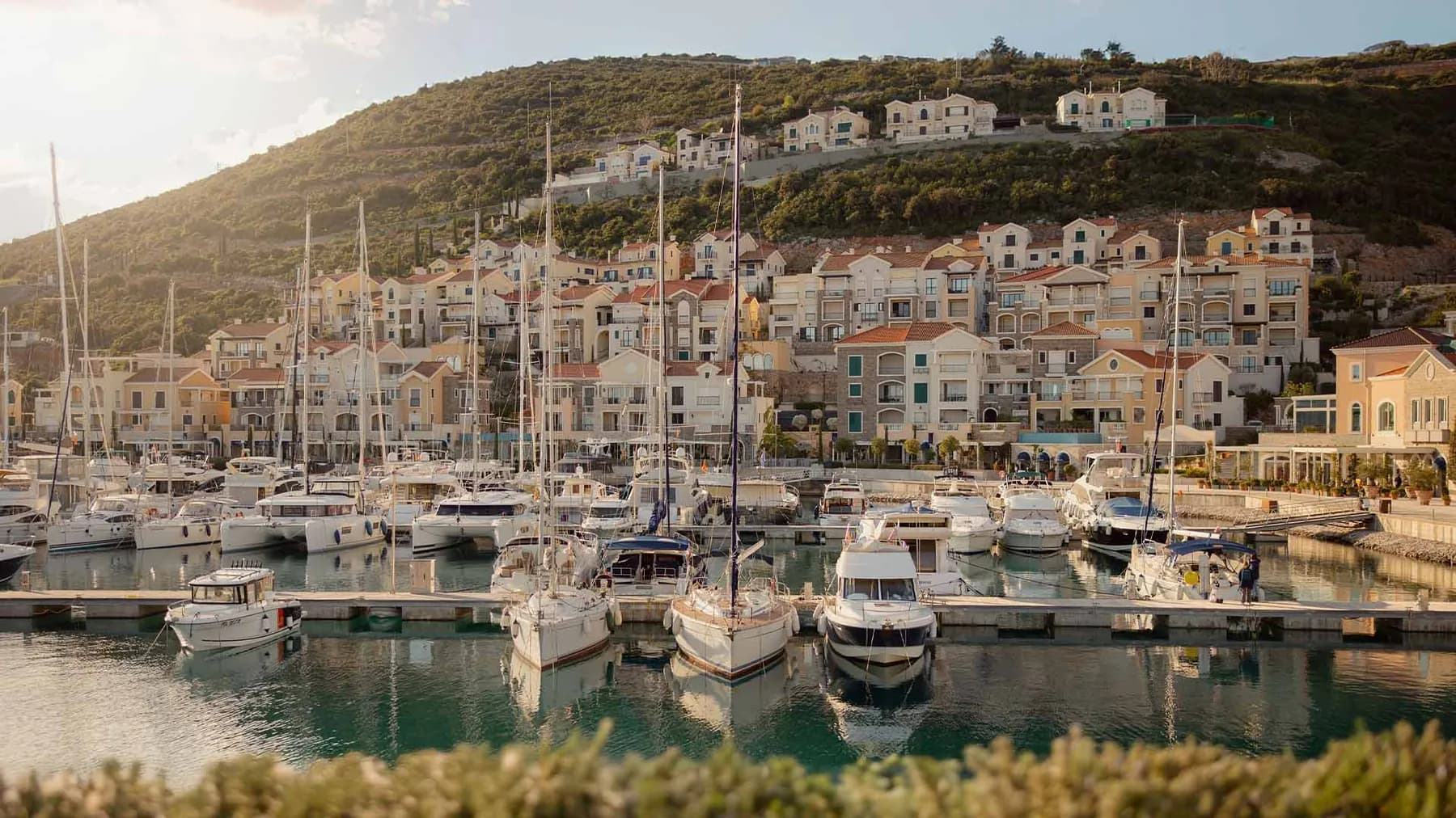 Luštica Bay marina village and waterfront residences at golden hour, Montenegro