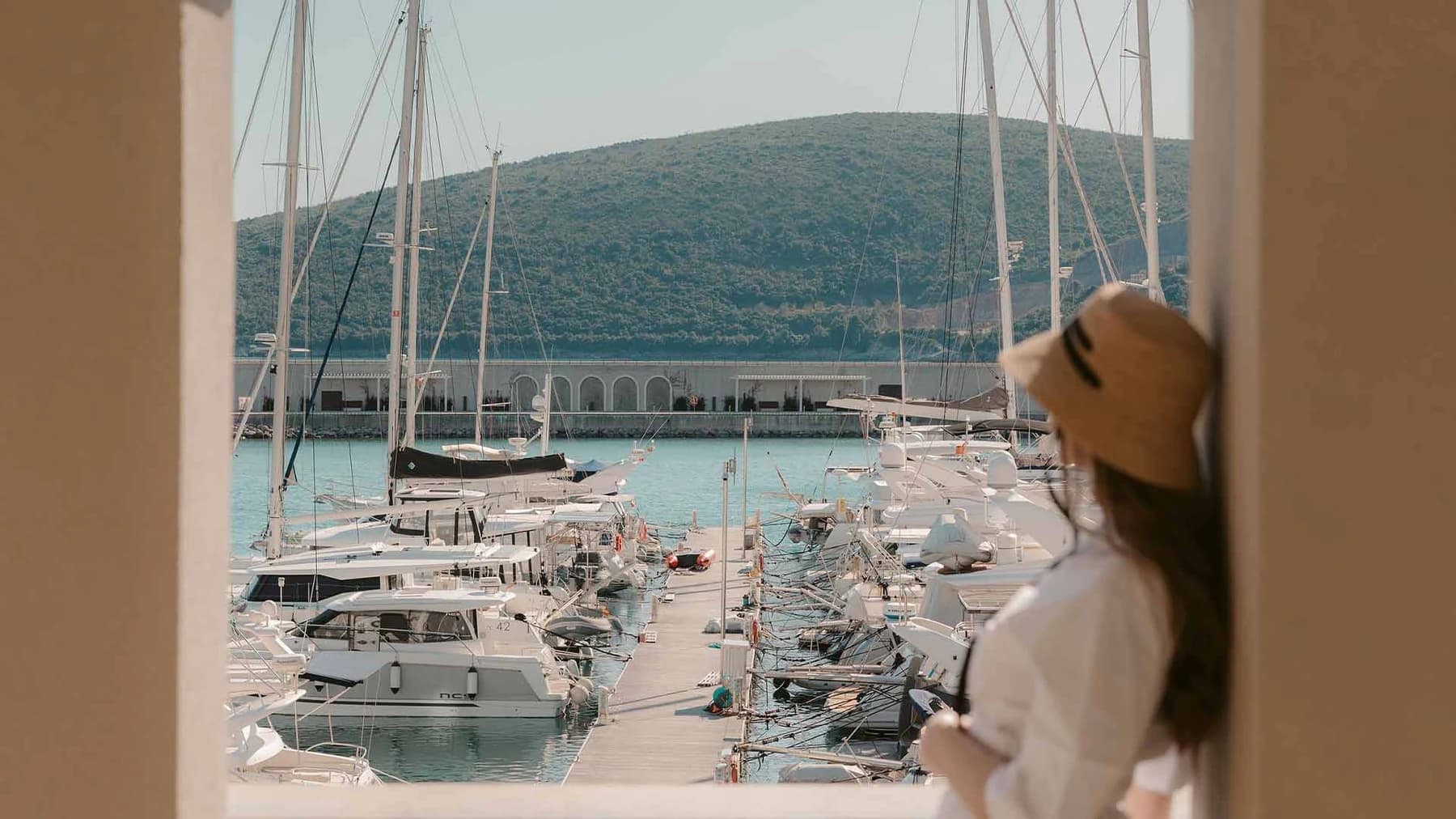 Looking out over the marina berths and the green hills of the bay from a waterfront residence